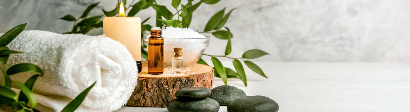 beauty treatment items for spa procedures on white wooden table.